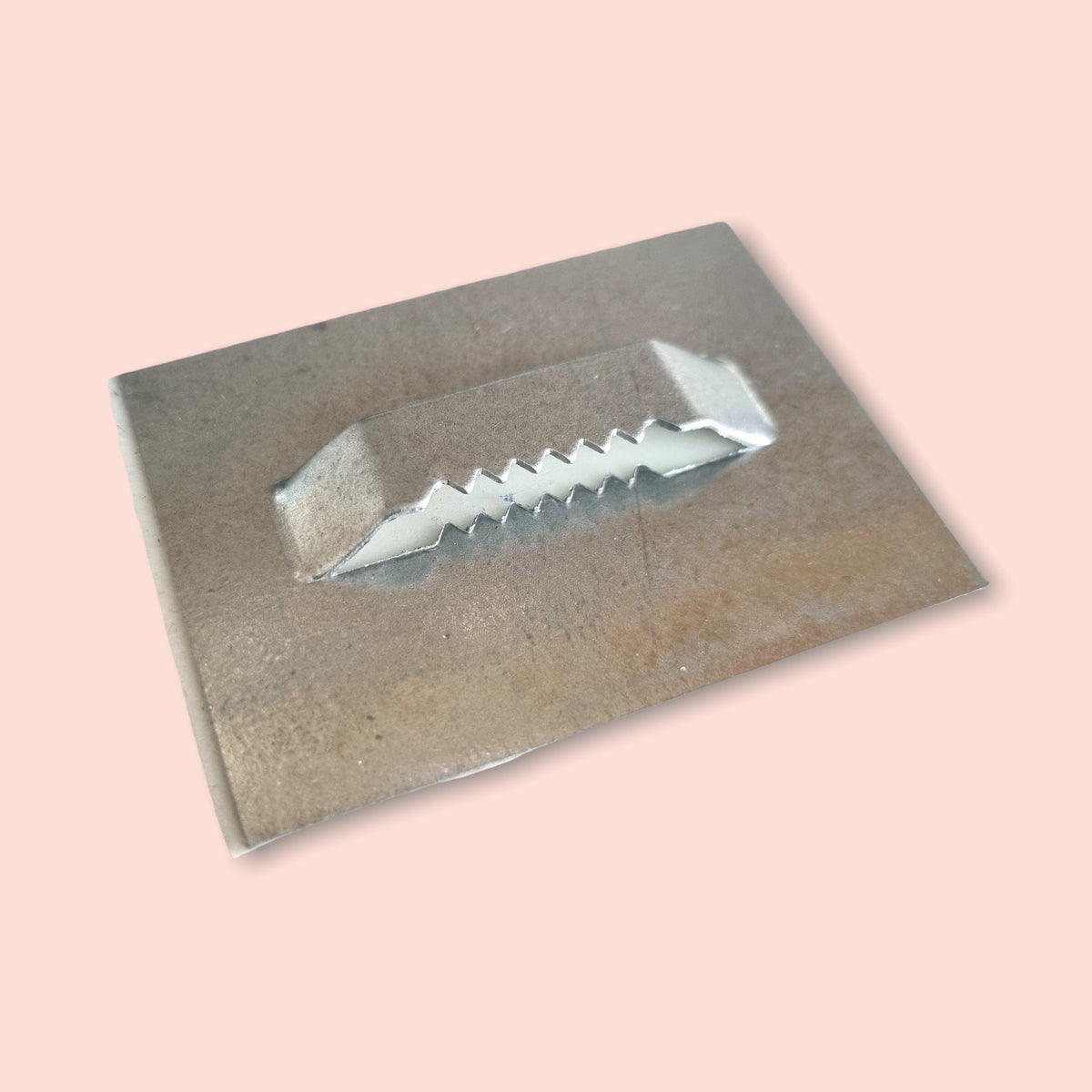 Rectangular silver metal sawtooth hanger hook used for mounting mirrors.