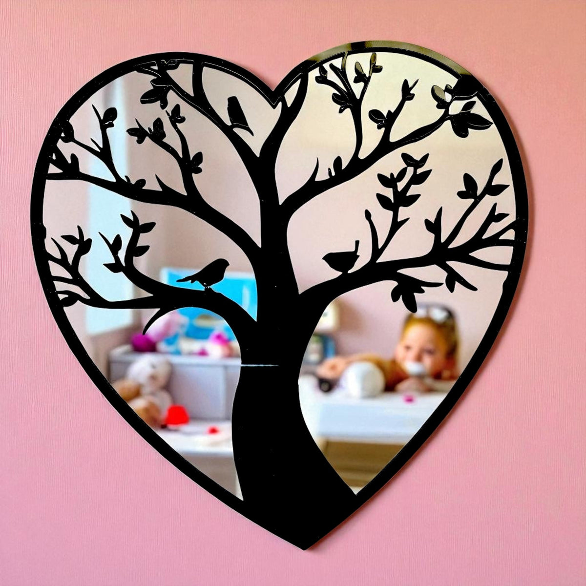 Heart-shaped mirror featuring a black tree of life design with perched birds across its branches.