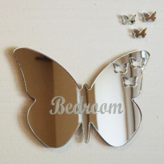 Silver butterfly-shaped mirror with "Bedroom" engraved and three small butterfly cutouts, plus three separate mini butterflies.