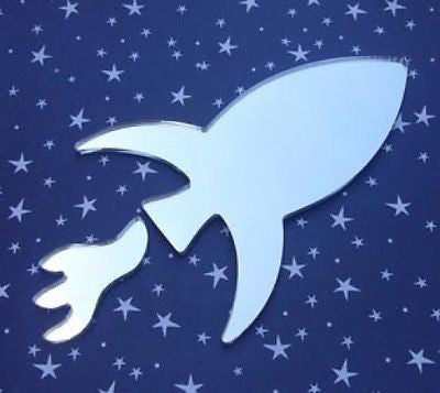 Rocket-shaped mirror with a detached flame piece, set against a dark blue star-patterned background.