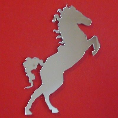 Silver mirrored acrylic cut into the shape of a rearing horse on a red background.