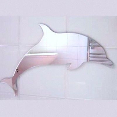 Dolphin-shaped mirror mounted on a white tiled wall.