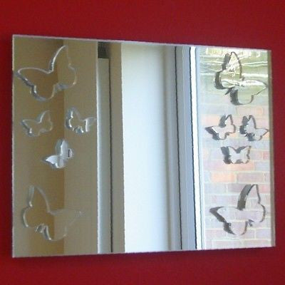 A rectangular mirror featuring butterfly-shaped cutouts along the left and right edges, mounted on a red wall.