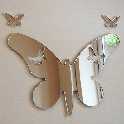 Silver butterfly-shaped mirror with long wings and two small butterfly cutouts, accompanied by two smaller mirrors.