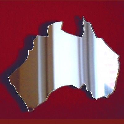 An Australia map-shaped mirror displayed against a solid dark red background.