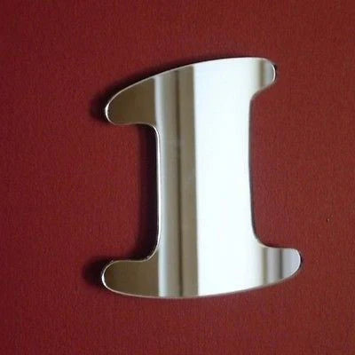 Number 1 shaped mirror in silver against a red background.