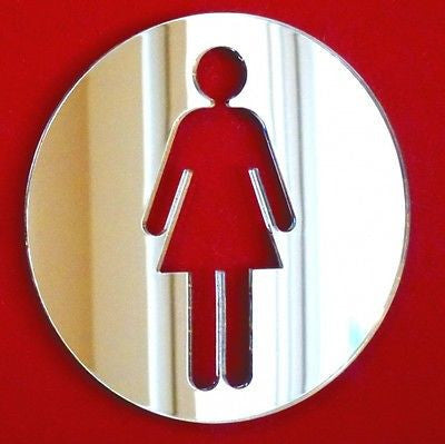 Round mirrored female toilet sign with a red cutout symbol on a red background.