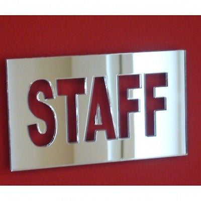 Rectangular silver mirror acrylic sign with cut-out "STAFF" text mounted on a red wall.