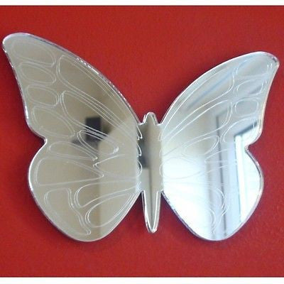 Etched butterfly-shaped wall mirror with outlined wing patterns on a red background.