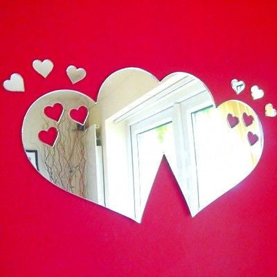 Two large joined heart-shaped mirrors with smaller heart mirrors, mounted on a red wall.