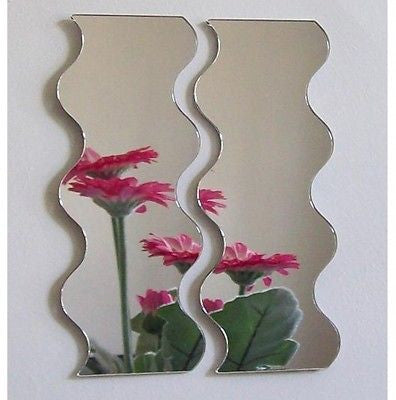 Pair of tall, vertical acrylic mirrors with wavy edges reflecting pink flowers.