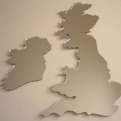 Two silver acrylic mirrors shaped like the maps of the UK and Ireland, mounted on a wall.