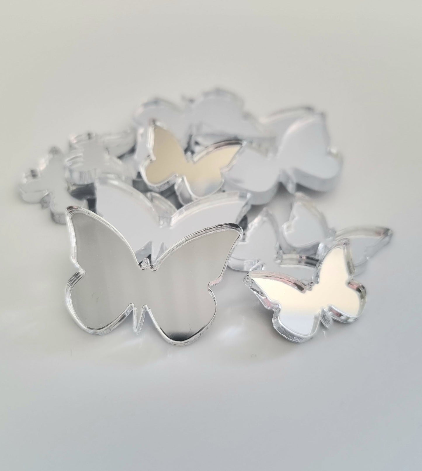 A bundle of silver decorative butterfly-shaped mirrors in various sizes.