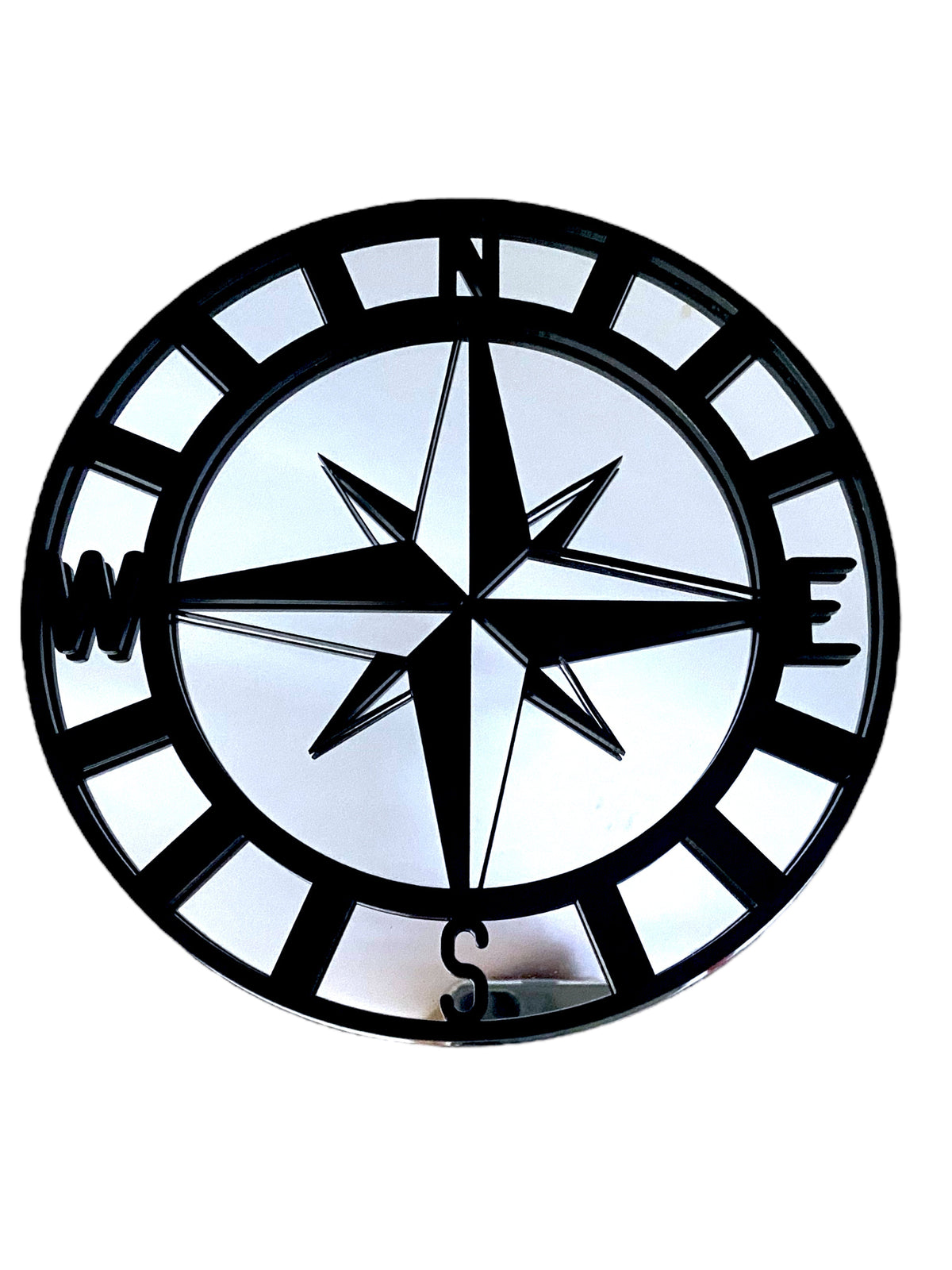 Round black metal garden mirror featuring a compass rose overlay with N, E, S, W markings.