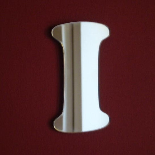 Letter I shaped mirror with curved edges, displayed against a dark red background.