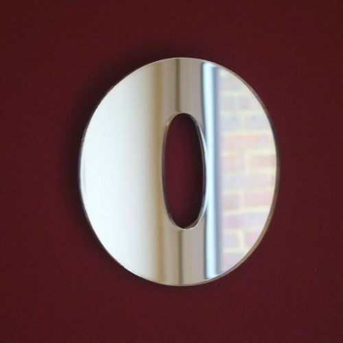 A silver mirror shaped like the letter O, mounted on a solid dark red background.