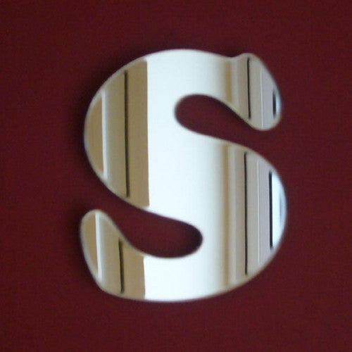 Silver mirror shaped like the letter S in a funky, rounded font against a red background.