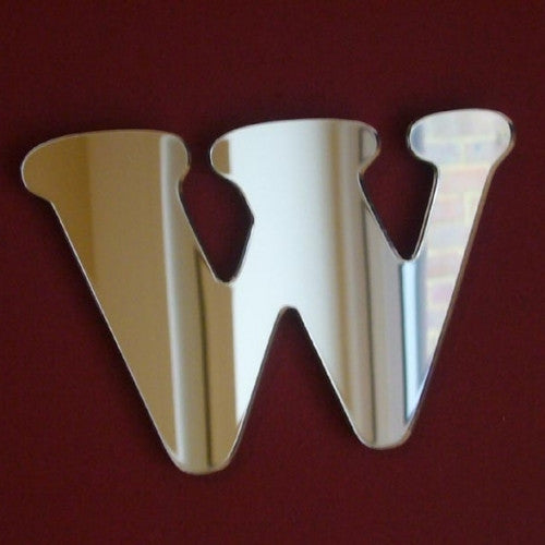 Silver acrylic mirror shaped like a funky, stylized letter W against a dark red background.