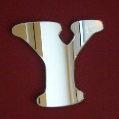 Letter Y shaped wall mirror with a funky, rounded design.