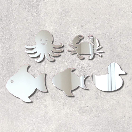 Bundle of five sea life-shaped mirrors including an octopus, crab, two fish, and a duck, on a gray wall.