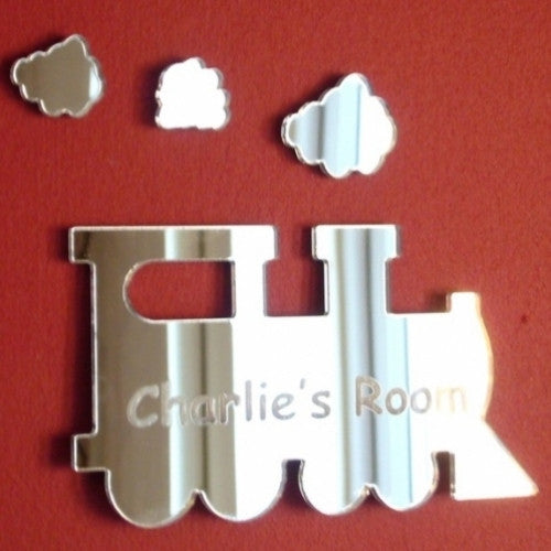 Steam train-shaped acrylic mirror with engraved text "Charlie's Room" and three cloud mirrors.