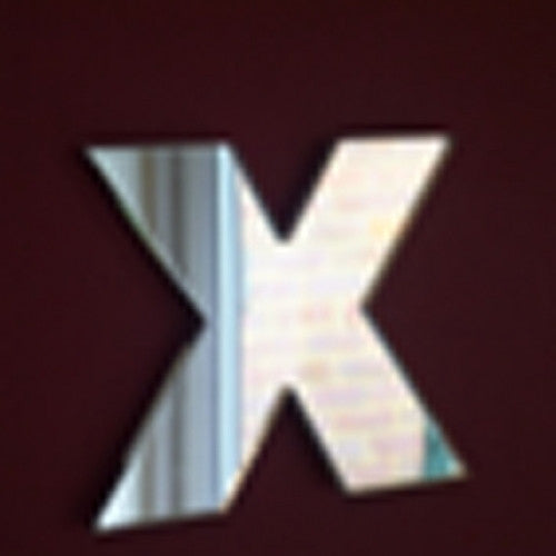 A wall mirror shaped like the letter X.