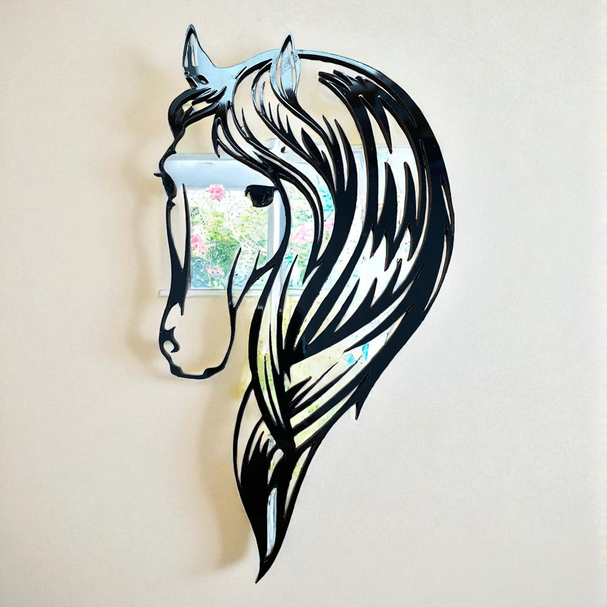 A horse head-shaped garden mirror featuring black linework depicting a horse's head and flowing mane.