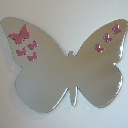 A butterfly-shaped mirror with smaller pink butterfly decals on its wings.