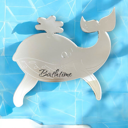 Etched whale-shaped silver mirror with the word "Bathtime" on a blue background.