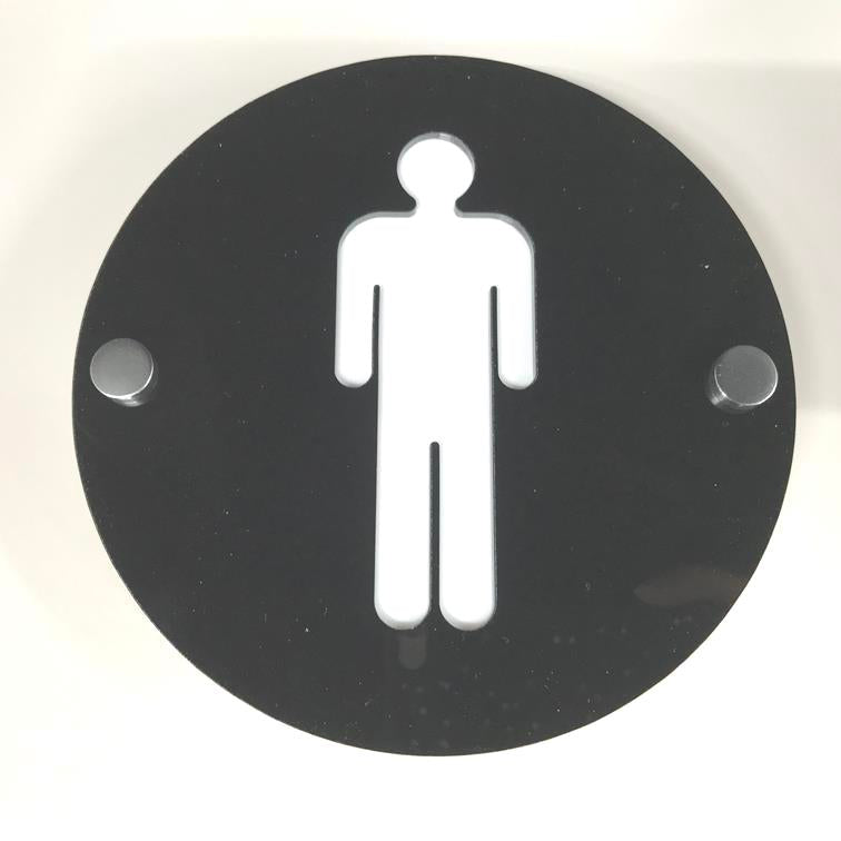 Round black acrylic male toilet sign with a white male symbol and two metal mounting standoffs.