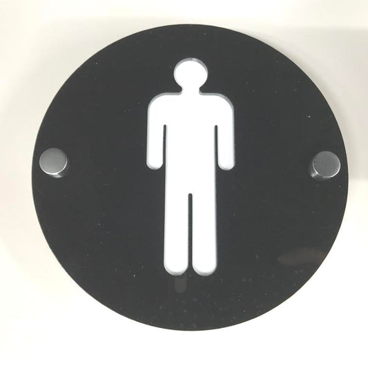 Round black acrylic male toilet sign with a white male symbol and two metal mounting standoffs.
