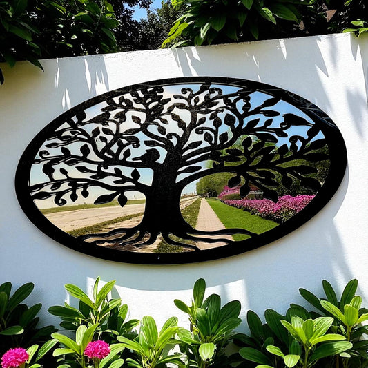 An oval mirror with a black metal Tree of Life overlay, mounted on a white garden wall.
