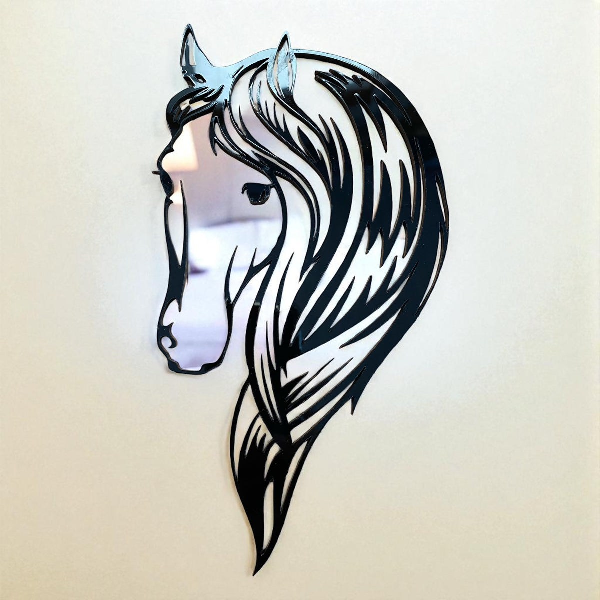 Horse head shaped garden mirror with black cut-out frame detailing mane and facial features.