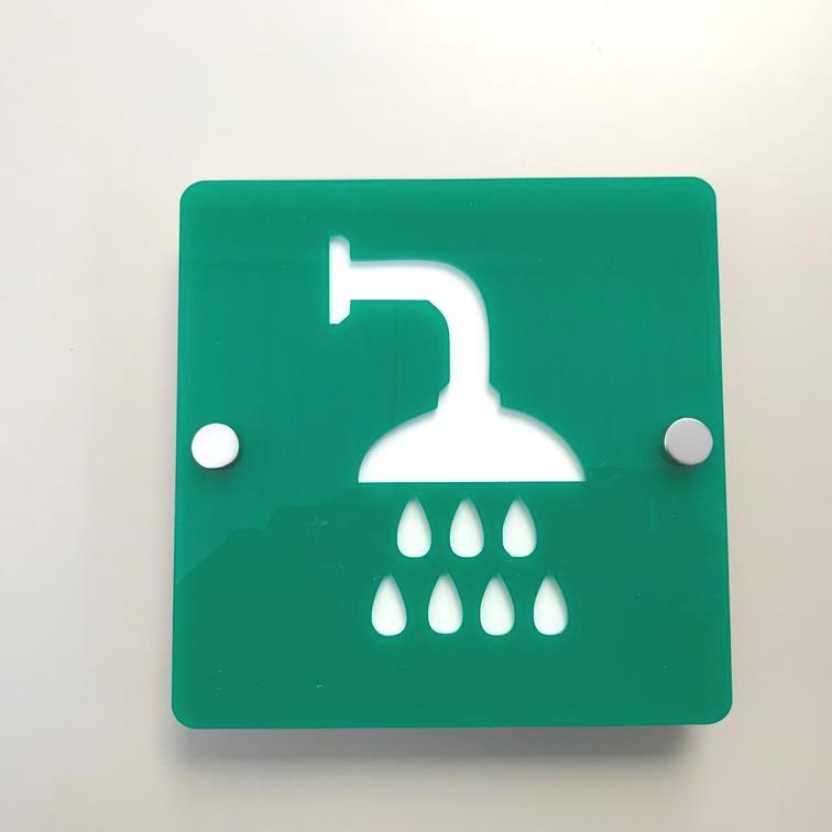 Square green acrylic shower room sign with a white shower icon and mounting standoffs.