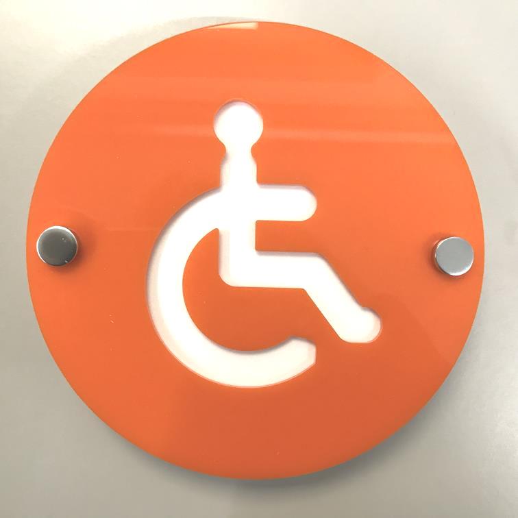 Round orange floating disabled toilet sign with a white wheelchair symbol, mounted with silver standoffs.