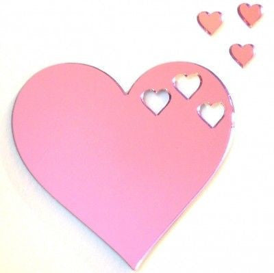 Pink acrylic heart-shaped mirror with three small heart cutouts and three separate mini heart mirror pieces.