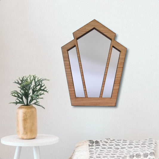 Art Deco wood-framed pentagon fan mirror hanging on a white wall.