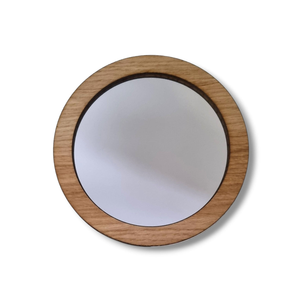 Round mirror with a light brown wood frame.