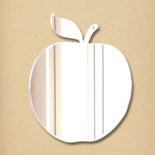 An apple-shaped acrylic mirror featuring a stem and leaf, reflecting light on a textured beige background.