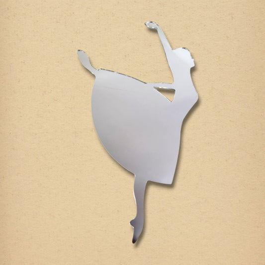 Silver acrylic mirror shaped like a dancing ballerina on a textured beige background.