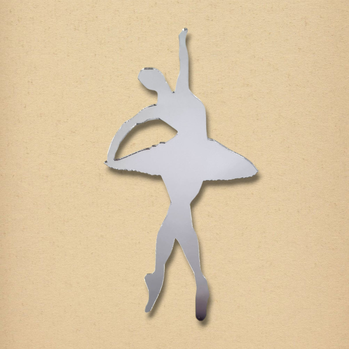 Ballerina tutu-shaped silver mirror on a light brown background.