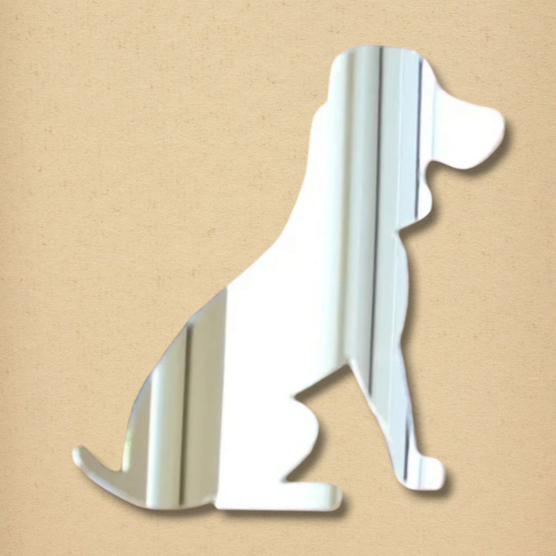 Beagle-shaped mirror in reflective silver, depicting a sitting dog silhouette against a tan background.
