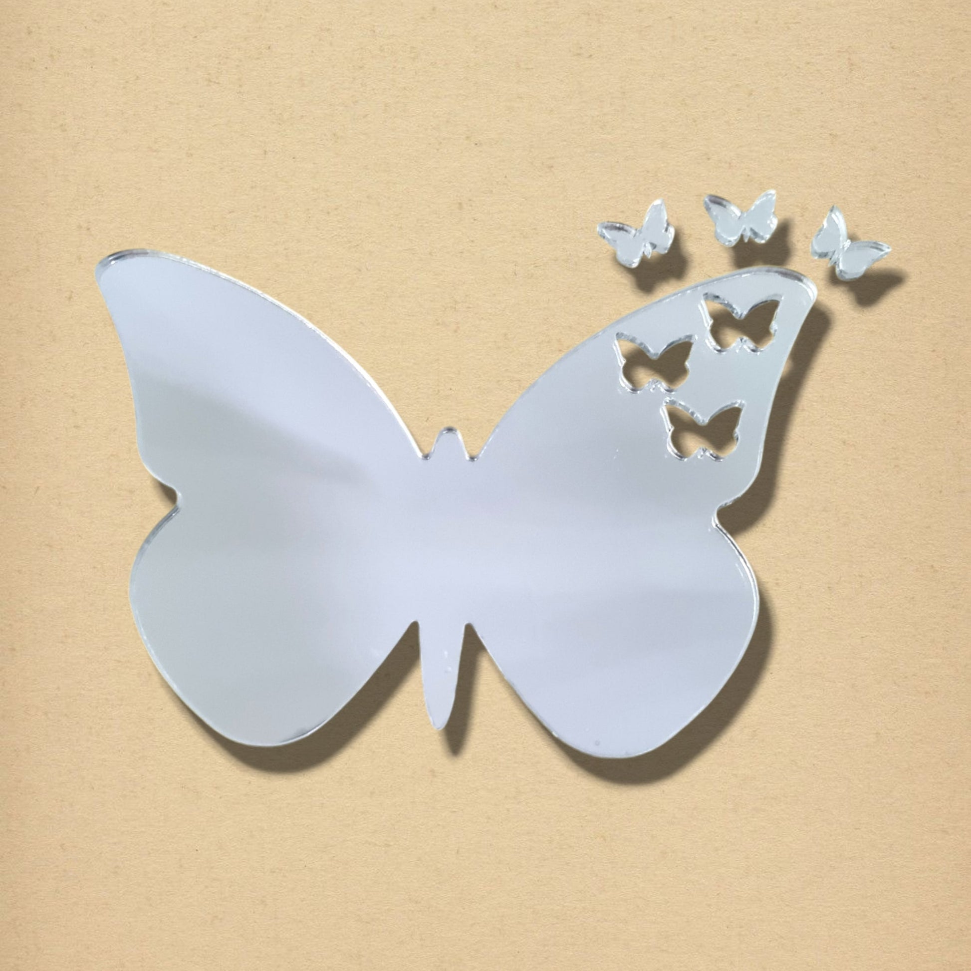 Butterfly-shaped mirror with three butterfly cutouts and three separate mini butterfly mirrors above it.