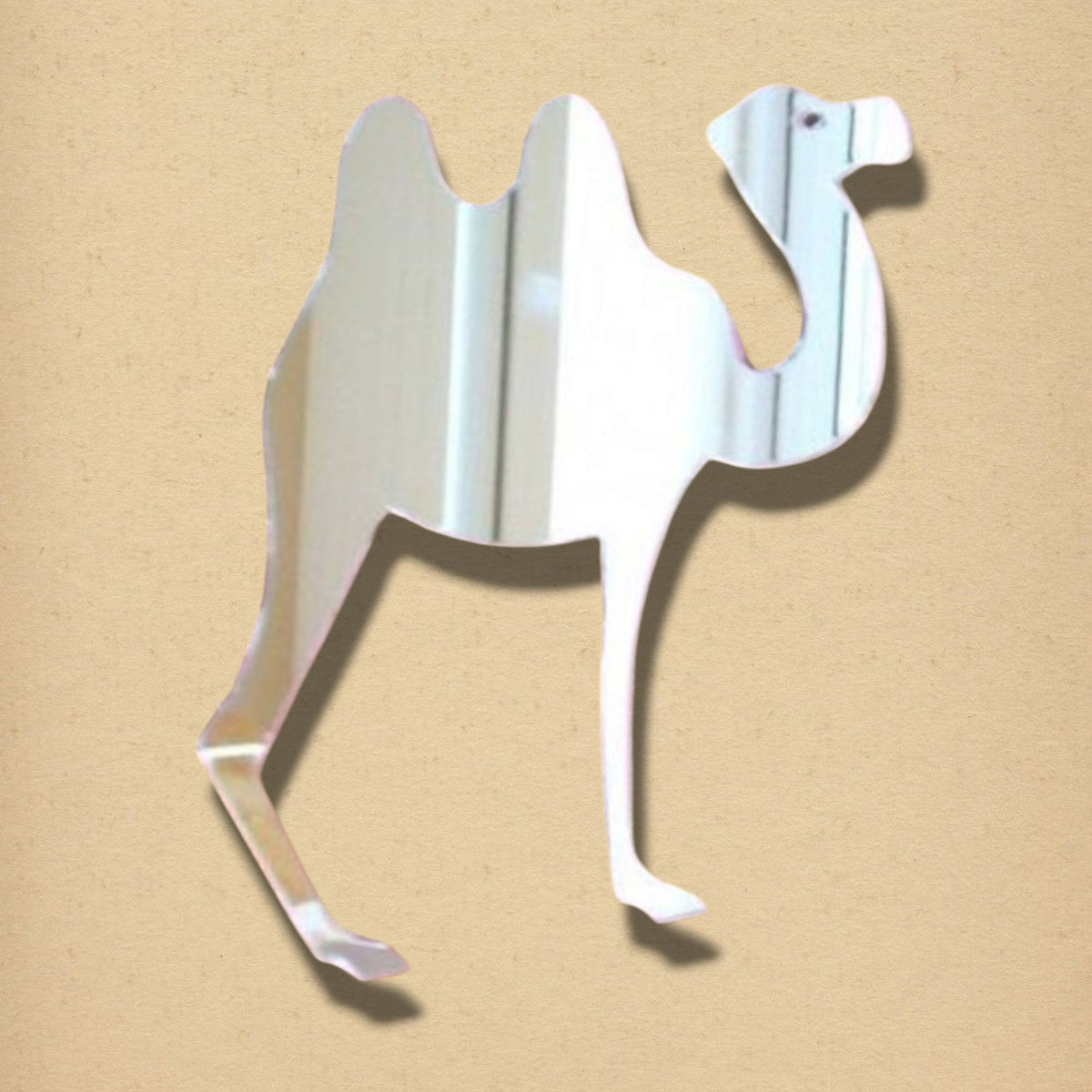 A double-humped camel-shaped mirror against a tan background.