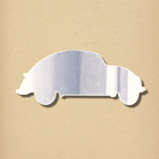 A silver, reflective acrylic mirror shaped like the side profile of a classic car, shown against a neutral beige background.