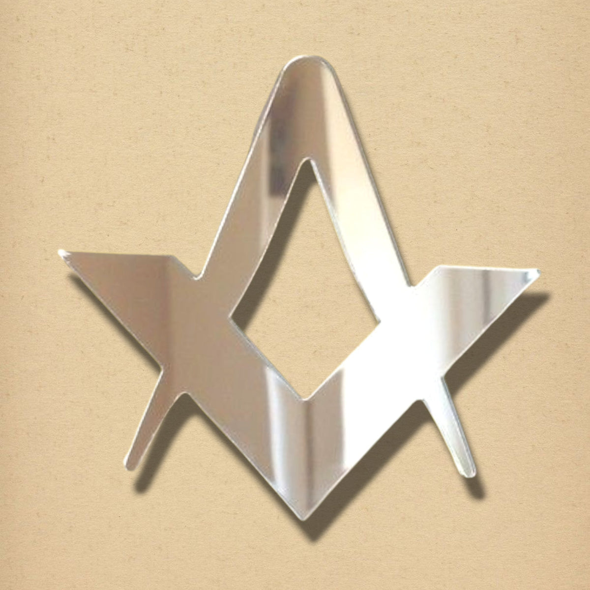 Freemasons compasses and set square acrylic mirror in silver on a tan background.