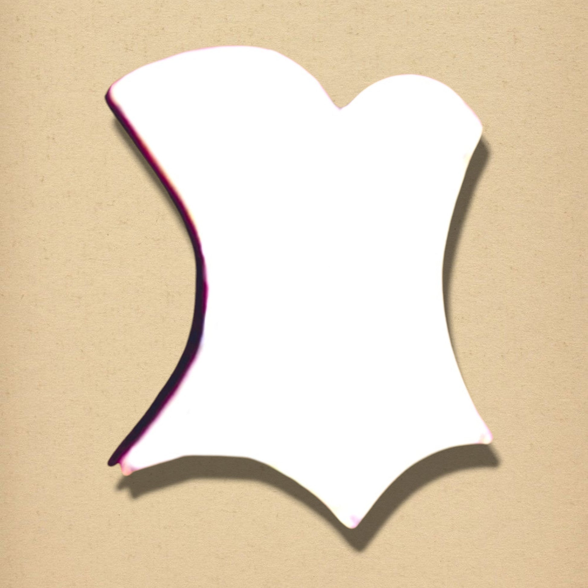 A white, bodice-shaped wall mirror with a curved, scalloped hemline against a textured beige background.