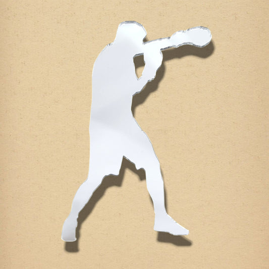 Boxer-shaped mirror on a textured beige background.