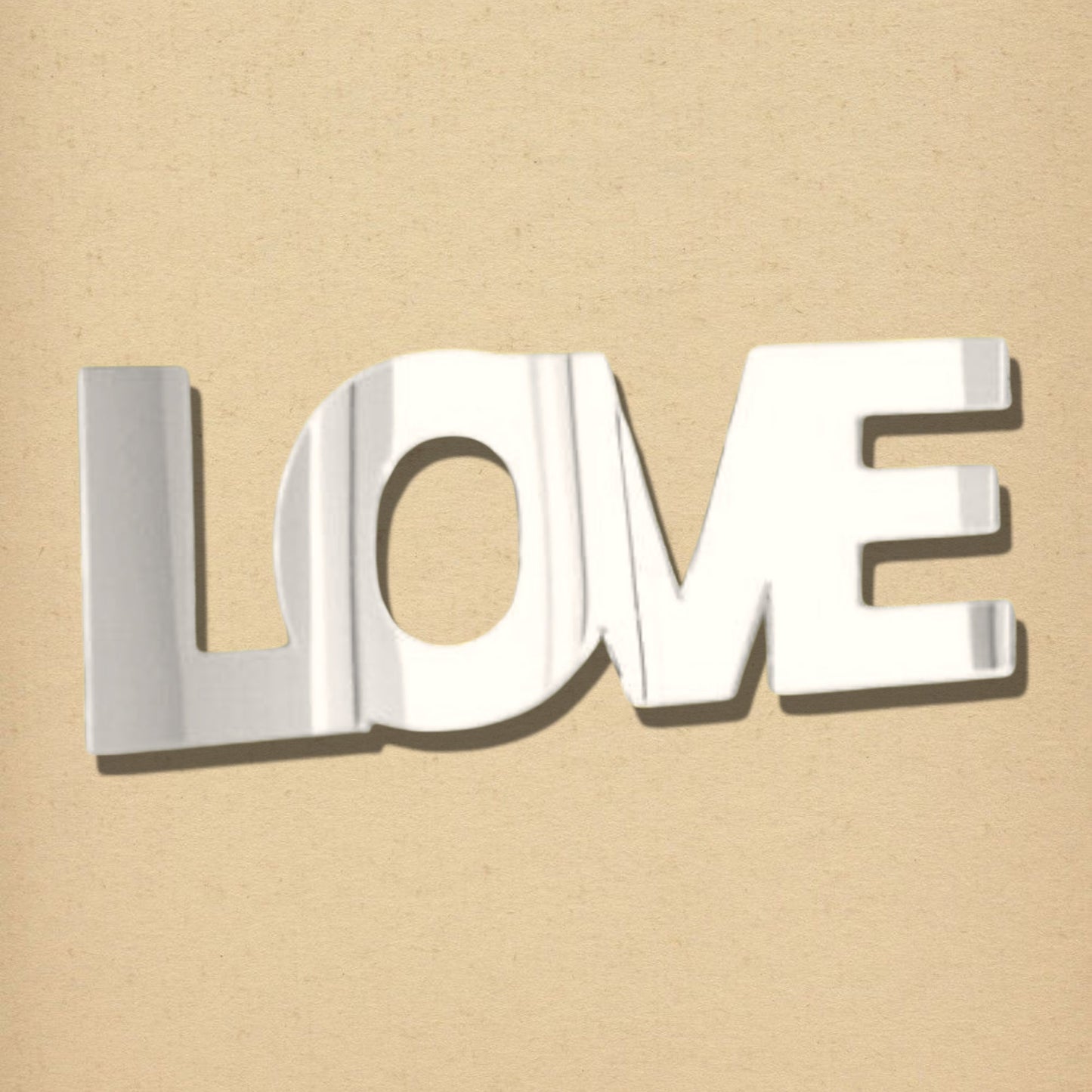 Silver reflective mirror shaped into the word "LOVE" on a tan background.