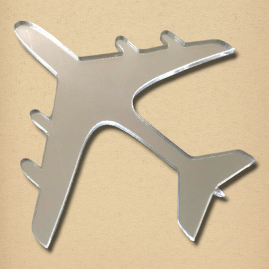 Aeroplane-shaped silver mirror on a light textured background.